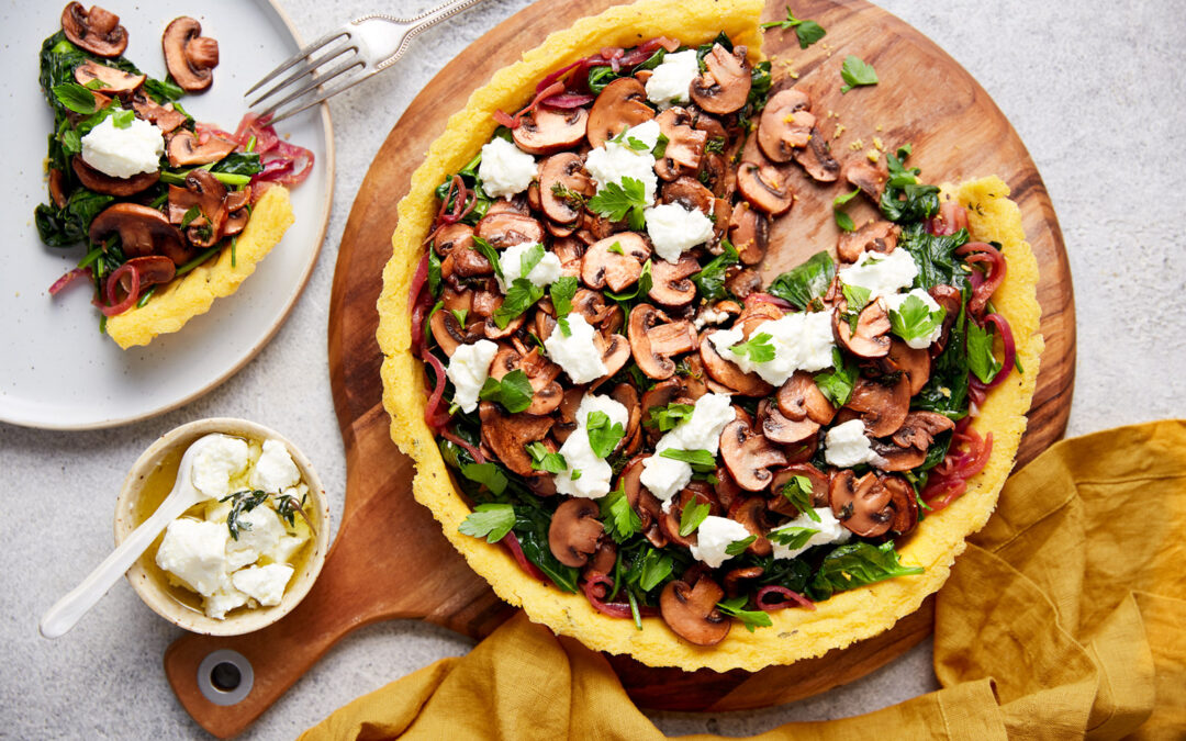 Baked polenta tart with sautéed mushrooms, caramelised red onion, and spinach